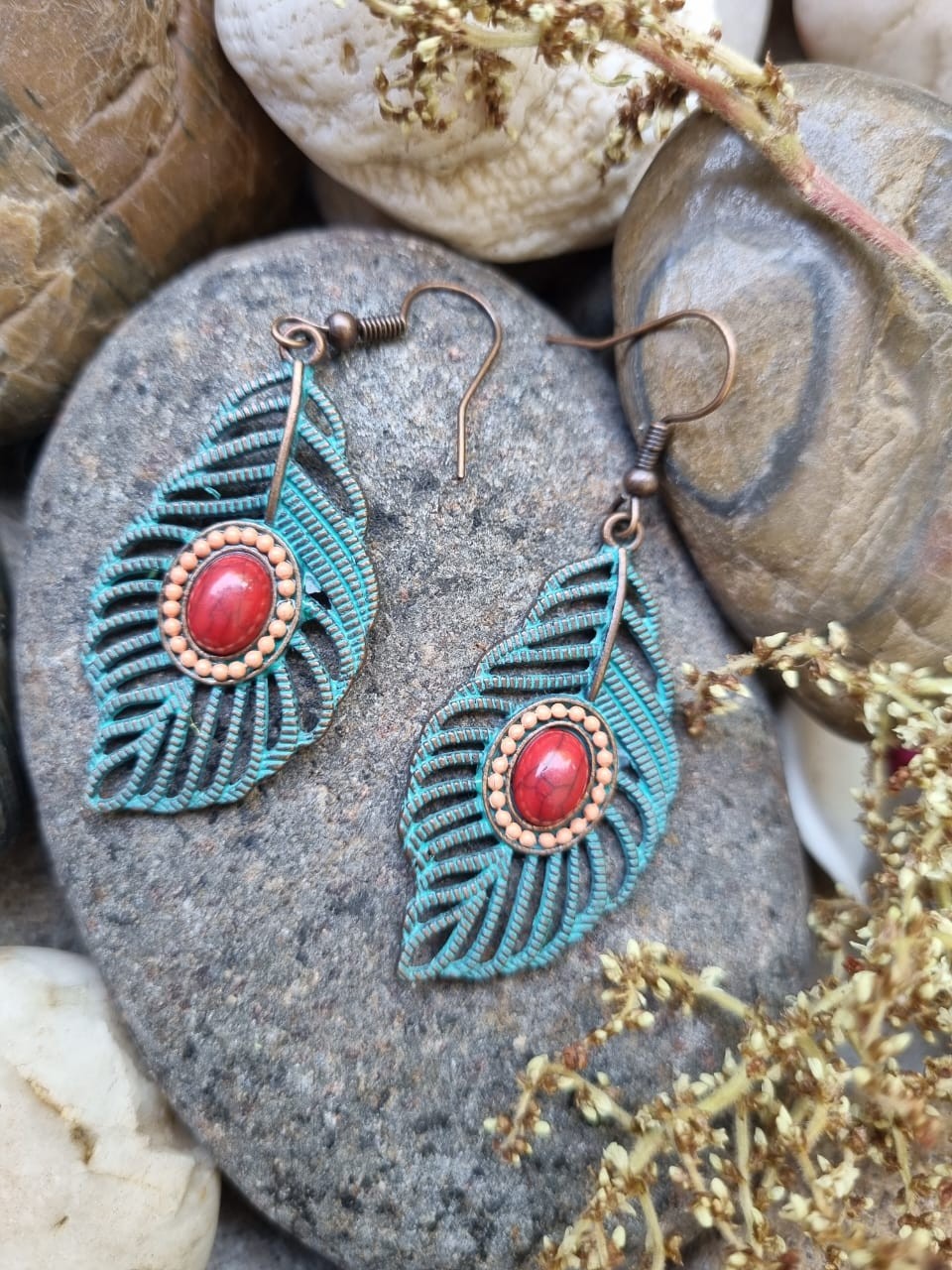 Bohemian style metal dangle earrings with a red stone