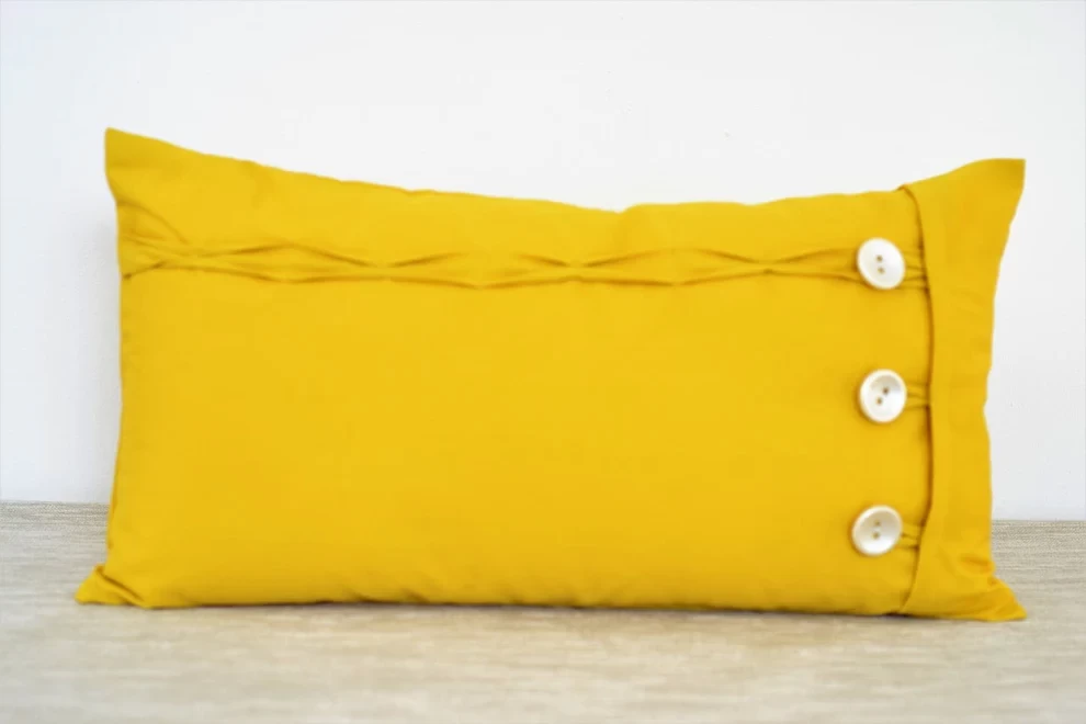 Yellow oblong cushion cover button and loop